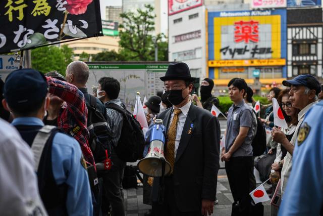 A participant looks on during a nationalist rally near Ikebukuro Station in Tokyo's Toshima district on May 4, 2026, where participants called for stricter immigration controls and denounced the Japan Communist Party. (Photo by Andrew CABALLERO-REYNOLDS / AFP)