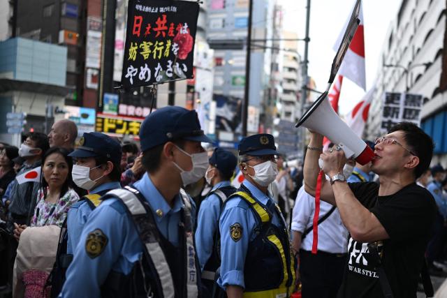 A counter protester shots during a nationalist rally near Ikebukuro Station in Tokyo's Toshima district on May 4, 2026, where participants called for stricter immigration controls and denounced the Japan Communist Party. (Photo by Andrew CABALLERO-REYNOLDS / AFP)