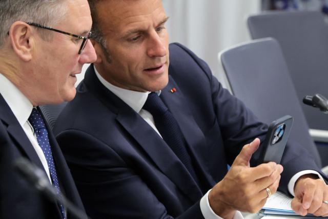 France's President Emmanuel Macron and Britain's Prime Minister Keir Starmer interact prior to a meeting of the Core Group in support of Moldova during the 8th European Political Community (EPC) summit in Yerevan on May 4, 2026. (Photo by Ludovic MARIN / AFP)