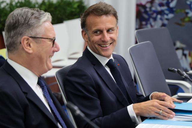 France's President Emmanuel Macron and Britain's Prime Minister Keir Starmer interact prior to a meeting of the Core Group in support of Moldova during the 8th European Political Community (EPC) summit in Yerevan on May 4, 2026. (Photo by Ludovic MARIN / AFP)