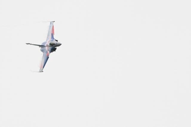 This photograph shows a Rafale Solo Display (RSD) aircraft, commanded by Captain Alexandre Roeckel, flying during the official presentation of the flight programme ahead of the start of the air show season at Nancy-Ochey air base 133 in Thuilley-aux-Groseilles on May 4, 2026. (Photo by Jean-Christophe VERHAEGEN / AFP)