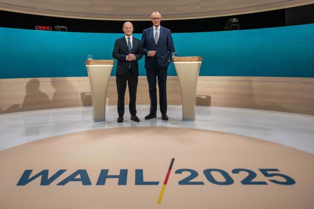 (FILES) Then German Chancellor Olaf Scholz (L), main candidate for the Social Democratic Party (SPD), and Friedrich Merz, then main candidate and chairman of the Christian Democratic Union (CDU) pose for a photo prior to the TV debate joint hosted by public broadcasters ARD and ZDF in Berlin on February 9, 2025, ahead of parliamentary elections due to take place on February 23, 2025. A year ago, German lawmakers elected conservative Friedrich Merz as chancellor. The chancellor had vowed to diminish the appeal of the country's far-right AfD party with two main strategies -- taking a tough stance on immigration to outflank the far-right party on the issue, and aiming to enact bold reforms to prove that centrist parties are still capable of acting. Tighter immigration rules have led to a significant decrease in arrivals -- but the chancellor does not appear to be benefitting political. Meanwhile the reform drive has stalled due to bickering between the conservative CDU and the social democratic SPD coalition parties, with the long-struggling economy making a slower than expected recovery. (Photo by Michael Kappeler / AFP)