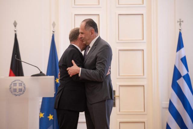 German Foreign Minister Johann Wadephul (L) hugs Greek Foreign Minister George Gerapetritis after a press conference at the Ministry of Foreign Affairs in Athens, on May 4, 2026. (Photo by Angelos TZORTZINIS / AFP)