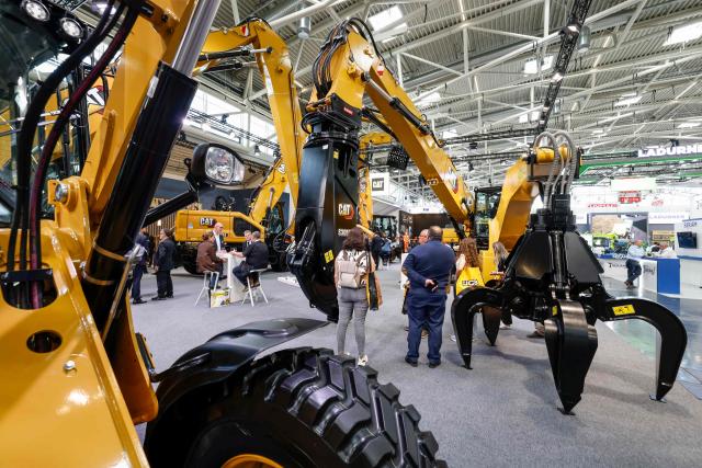 Fair goers stand among machines at the IFAT Munich, a trade fair dedicated to environmental technologies across water, wastewater, waste and resource management, in Munich, southern Germany, on May 4, 2026. According to organisers, more than 3,000 exhibitors from more than 60 countries are presenting their strategies and innovations during the fair running until May 7, 2026. (Photo by Michaela STACHE / AFP)