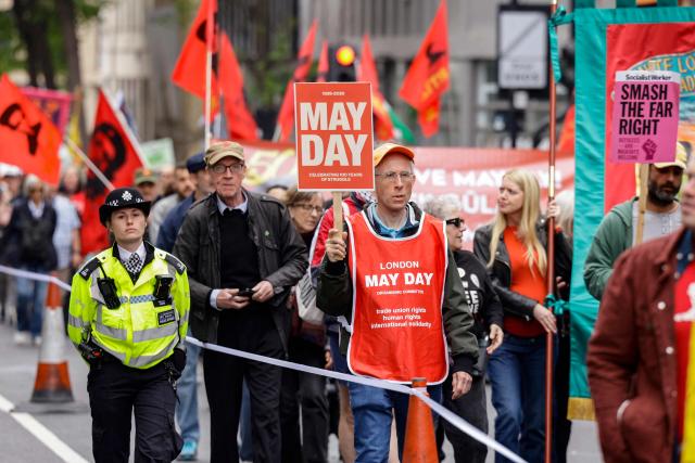 People hold placards and banners as they take part in a May Day march and rally in central London on May 4, 2026, to mark the 100th anniversary of the "General Strike" in 1926. (Photo by Brook Mitchell / AFP)