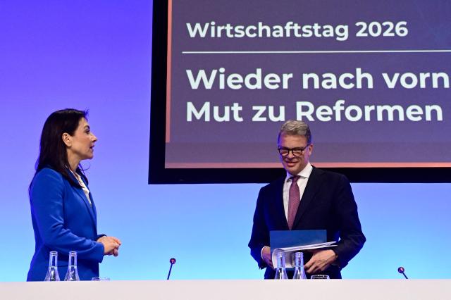 German Economy and Energy Minister Katherina Reiche and Deutsche Bank CEO Christian Sewing attend the economic policy summit (Wirtschaftstag) in Berlin on May 4, 2026. The two-day summit brings together key players from politics and business. (Photo by John MACDOUGALL / AFP)