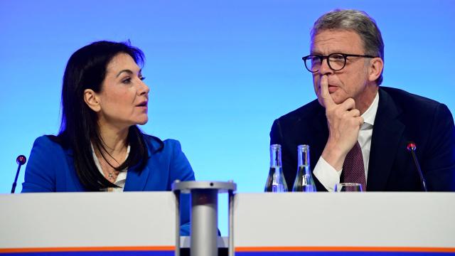 German Economy and Energy Minister Katherina Reiche and Deutsche Bank CEO Christian Sewing speak as they attend the economic policy summit (Wirtschaftstag) in Berlin on May 4, 2026. The two-day summit brings together key players from politics and business. (Photo by John MACDOUGALL / AFP)