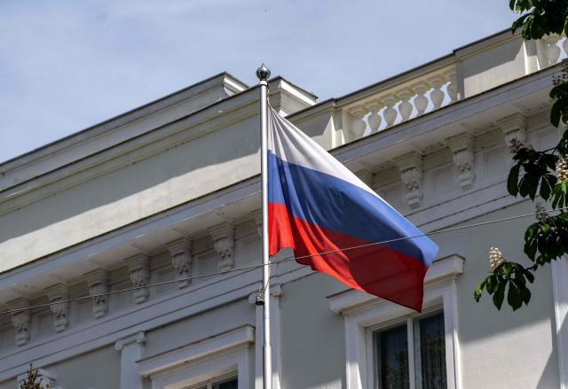A Russian flag flies in front of the Embassy of the Russian Federation is seen in Vienna, Austria on May 4, 2026. Austria said it had expelled three Russian embassy staff on suspicion of spying, with the foreign minister vowing a "change of course" and a crackdown on espionage. The Russian embassy said there would be a "harsh" response. (Photo by Joe Klamar / AFP)
