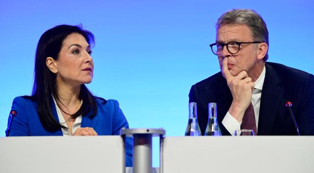 German Economy and Energy Minister Katherina Reiche and Deutsche Bank CEO Christian Sewing speak as they attend the economic policy summit (Wirtschaftstag) in Berlin on May 4, 2026. The two-day summit brings together key players from politics and business. (Photo by John MACDOUGALL / AFP)