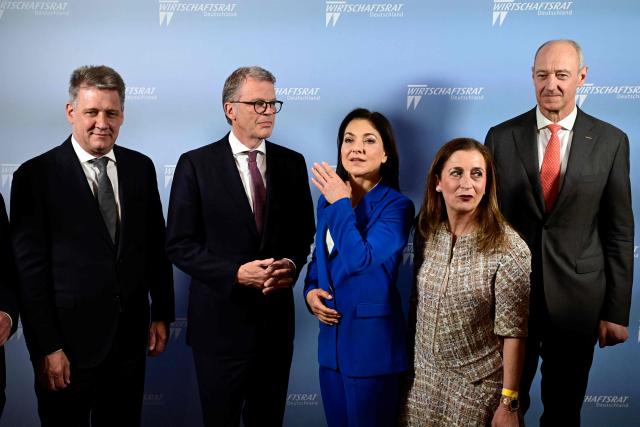 (From L) The Chairman of the Board of Management of AUDI AG Gernot Doellner, Deutsche Bank CEO Christian Sewing, German Economy and Energy Minister Katherina Reiche, President of the Economic Council of the Christian Democratic Union (CDU) Astrid Hamker, and Chairman of the Board of Siemens AG Roland Busch pose for photos during the economic policy summit (Wirtschaftstag) in Berlin on May 4, 2026. The two-day summit brings together key players from politics and business. (Photo by John MACDOUGALL / AFP)