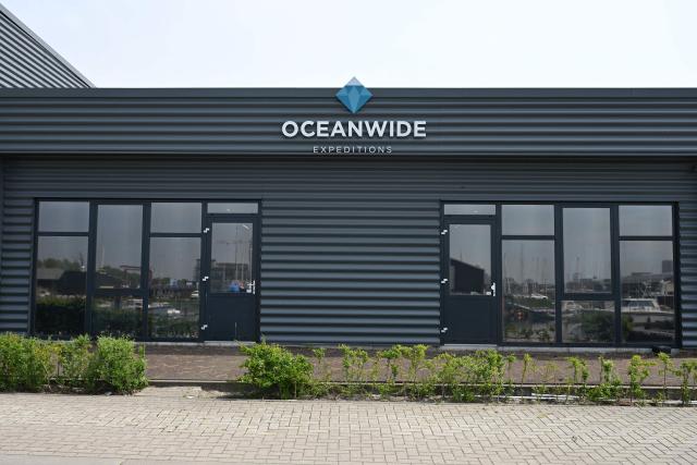 This photograph shows the logo of Oceanwide Expeditions at the headquarters in Vlissingen on May 4, 2026. Strict precautionary measures including isolation are in place on a cruise ship anchored off Cape Verde on which a suspected outbreak of hantavirus has killed three people, the cruise operator  said on May 4, 2026. (Photo by Nicolas TUCAT / AFP)