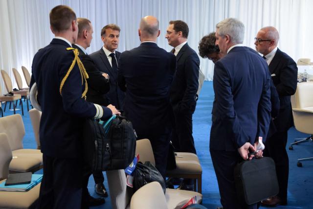 France's President Emmanuel Macron talks to his advisors at the end of the 8th European Political Community (EPC) summit in Yerevan on May 4, 2026. (Photo by Ludovic MARIN / AFP)