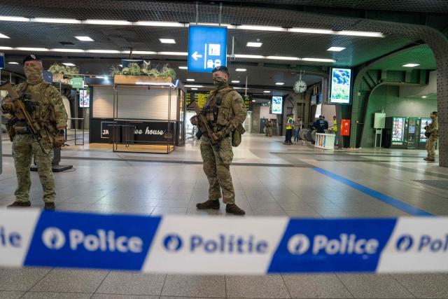 Soldiers stand guard in the hall of the Gare du Midi, Brussels South railway station, where the traffic has been suspended after a suspect package was found in Brussels on May 4, 2026. (Photo by Marius BURGELMAN / Belga / AFP) / Belgium OUT