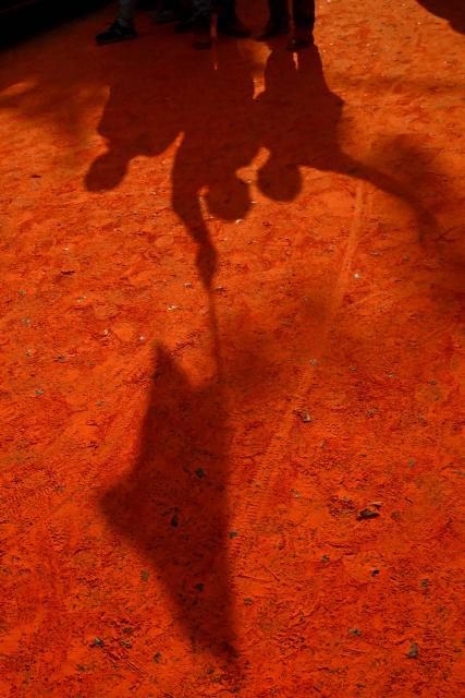 The shadows of Bharatiya Janata Party (BJP) supporters are seen as they celebrate after taking a lead during vote counting for the West Bengal Legislative Assembly elections, near the party head office in Kolkata on May 4, 2026. Indian Prime Minister Narendra Modi claimed a "record" victory on May 4 in key elections in opposition-held West Bengal state after official trends and partial results showed a thumping majority for his Hindu nationalist party. (Photo by Dibyangshu SARKAR / AFP)