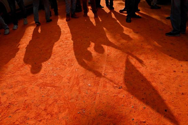 The shadows of Bharatiya Janata Party (BJP) supporters are seen as they celebrate after taking a lead during vote counting for the West Bengal Legislative Assembly elections, near the party head office in Kolkata on May 4, 2026. Indian Prime Minister Narendra Modi claimed a "record" victory on May 4 in key elections in opposition-held West Bengal state after official trends and partial results showed a thumping majority for his Hindu nationalist party. (Photo by Dibyangshu SARKAR / AFP)