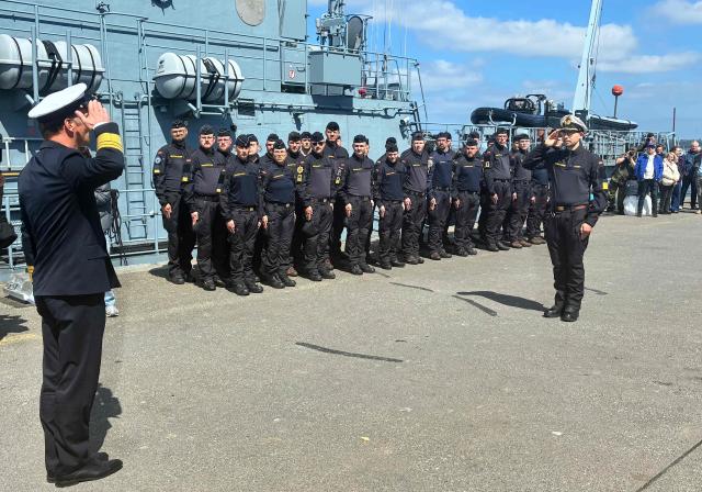 Marine soldiers of the German Navy's minesweeper 'Fulda' stand to attention during a ceremony prior to the ship's departure from the harbour of Kiel, northern Germany, on May 4, 2026, for the Mediterranean as part of a pre-deployment operation in preparation for a possible mission in the Strait of Hormuz. Minesweepers are specialised vessels used to detect and set off naval mines. The ship will be stationed with a crew of about 45. (Photo by Sandra BECKEFELDT / AFP)