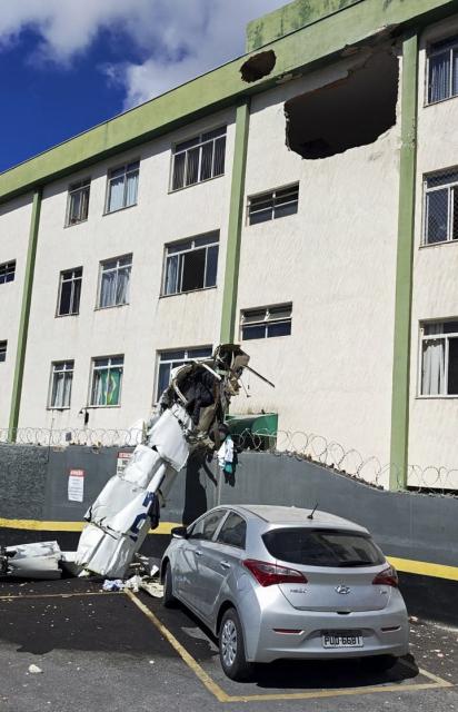 This handout picture released by the Minas Gerais Fire Department shows a small plane after it crashed into a building in the city center of Belo Horizonte, Minas Gerais state, Brazil, on May 4, 2026. (Photo by Handout / MINAS GERASIS FIRE DEPARTMENT / AFP)