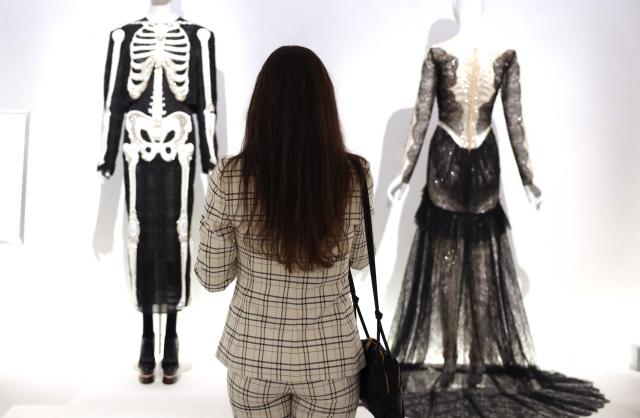 A person checks out fashion designs during the press preview of the 2026 Met Gala celebrating "Costume Art" at the Metropolitan Museum of Art in New York City on May 4, 2026. Jeff Bezos and his wife Lauren Sanchez Bezos are lead sponsors and honorary co-chairs of the high-profile fundraising event which draws A-listers across entertainment, sport, fashion and business. (Photo by TIMOTHY A. CLARY / AFP)