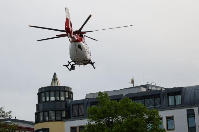 A helicopter of the DRF, German emergency medical services flies overhead at the scene where a car ploughed into people on a street leaving at least two dead and several injured, in the city centre in Leipzig, eastern Germany on May 4, 2026. "A car drove through the city center," a police spokeswoman told AFP news agency. The spokeswoman could not initially give a specific number of injured. The situation is "unclear." (Photo by Jens SCHLUETER / AFP)