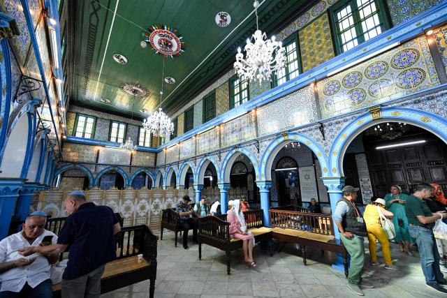 French Jewish pilgrims gather at the Ghriba synagogue, Africa's oldest synagogue, on Tunisia's southern island of Djerba on May 4, 2026 during the annual pilgrimage to the Jewish holy site. This year's Jewish pilgrimage on Tunisia's island of Djerba will welcome more worshippers after two years of scaled-down participation due to safety concerns, organisers had said on April 14. The pilgrimage to Ghriba has in the past drawn thousands of pilgrims from Europe and beyond, attracting international and local tourists as well. (Photo by FETHI BELAID / AFP)