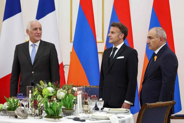 Armenia's President Vahagn Khachaturyan, France's President Emmanuel Macron and Armenia's Prime Minister Nikol Pashinyan attend a state dinner in honour of the French leader at the presidential palace in Yerevan on May 4, 2026. (Photo by Ludovic MARIN / AFP)