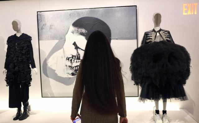 A person attends an exhibition of fashion designs during the press preview of the 2026 Met Gala celebrating "Costume Art" at the Metropolitan Museum of Art in New York City on May 4, 2026. Jeff Bezos and his wife Lauren Sanchez Bezos are lead sponsors and honorary co-chairs of the high-profile fundraising event which draws A-listers across entertainment, sport, fashion and business. (Photo by TIMOTHY A. CLARY / AFP)