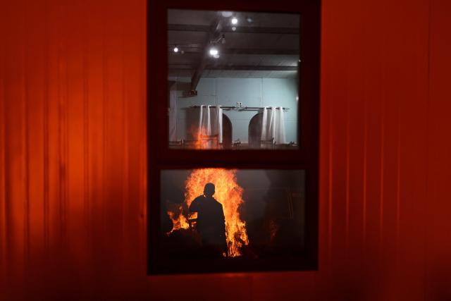 Bonfires are reflected on windows as Ultra-Orthodox Jews celebrate Lag BaOmer in Jerusalem on May 4, 2026. Lag BaOmer marks the anniversary of the death of Talmudic sage Rabbi Shimon Bar Yochai approximately 1,900 years ago. (Photo by Ilia YEFIMOVICH / AFP)