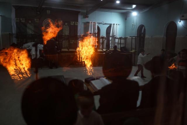 Bonfires are reflected on windows as Ultra-Orthodox Jews celebrate Lag BaOmer in Jerusalem on May 4, 2026. Lag BaOmer marks the anniversary of the death of Talmudic sage Rabbi Shimon Bar Yochai approximately 1,900 years ago. (Photo by Ilia YEFIMOVICH / AFP)