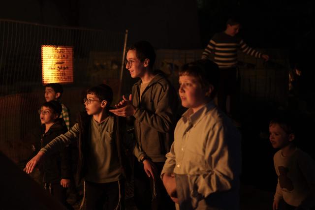 Ultra-Orthodox Jewish boys gather around a bonfire as they celebrate Lag BaOmer in Jerusalem on May 4, 2026. Lag BaOmer marks the anniversary of the death of Talmudic sage Rabbi Shimon Bar Yochai approximately 1,900 years ago. (Photo by Ilia YEFIMOVICH / AFP)