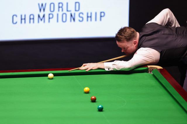 England's Shaun Murphy plays a shot against China's Wu Yize during the World Snooker Championship final round at The Crucible in Sheffield, northern England on May 4, 2026. (Photo by Darren Staples / AFP)