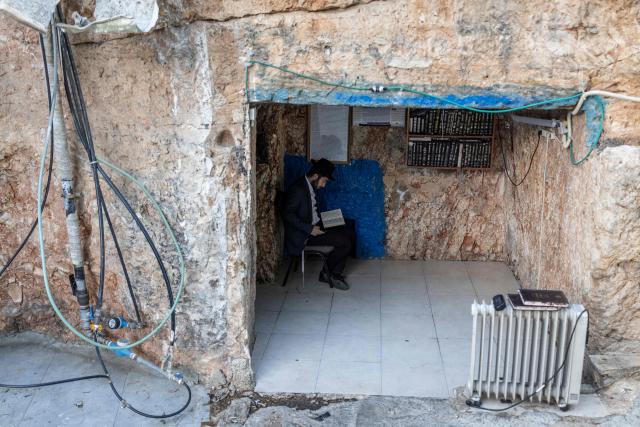 An Ultra Orthodox Jewish man prays at the tomb of “Shimon Hazadik” (Simeon the Just) during the Jewish holiday of Lag BaOmer in the east Jerusalem neighborhood of Sheikh Jarrah on May 4, 2026. Lag BaOmer marks the anniversary of the death of Talmudic sage Rabbi Shimon Bar Yochai approximately 1,900 years ago. (Photo by ilia YEFIMOVICH / AFP)