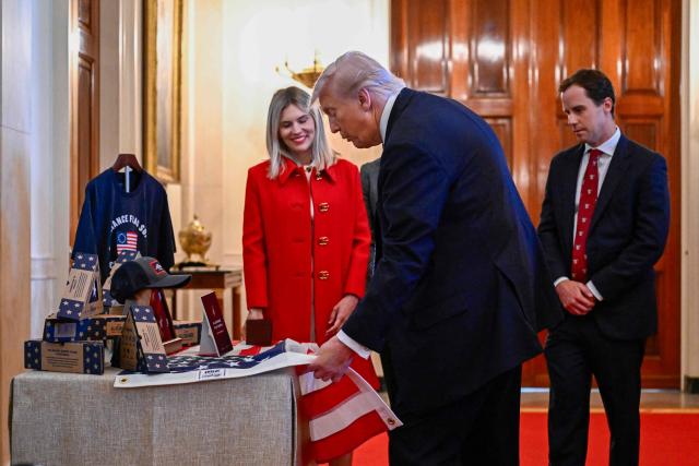US President Donald Trump checks products at a business stand during a Small Business Summit in the East Room of the White House in Washington, DC on May 4, 2026. (Photo by Kent NISHIMURA / AFP)