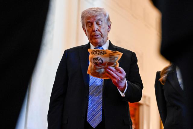 US President Donald Trump checks a product at a business stand during a Small Business Summit in the East Room of the White House in Washington, DC on May 4, 2026. (Photo by Kent NISHIMURA / AFP)