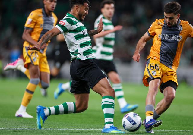 Sporting Lisbon's Colombian forward #97 Luis Suarez (L) vies for the ball with Vitoria Guimaraes's French born Romanian defender # 66 Tony Strata during the Portuguese League football match between Sporting CP and Vitoria Guimaraes SC at Jose Alvalade stadium in Lisbon, on May 4, 2026. (Photo by PATRICIA DE MELO MOREIRA / AFP)