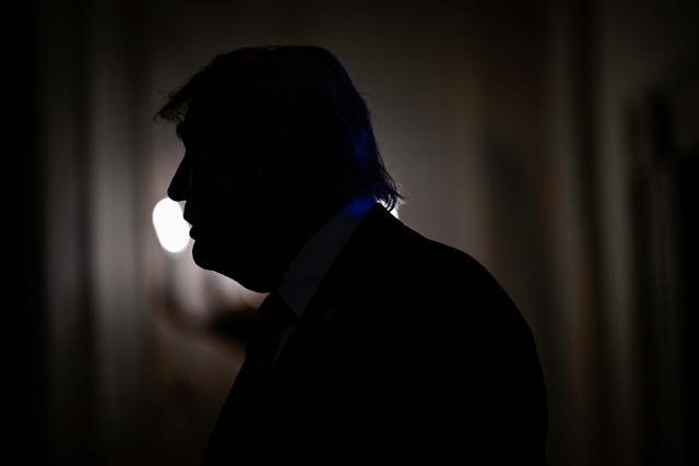 US President Donald Trump is pictured silhouetted as he participates in a Small Business Summit in the East Room of the White House in Washington, DC on May 4, 2026. (Photo by Kent NISHIMURA / AFP)