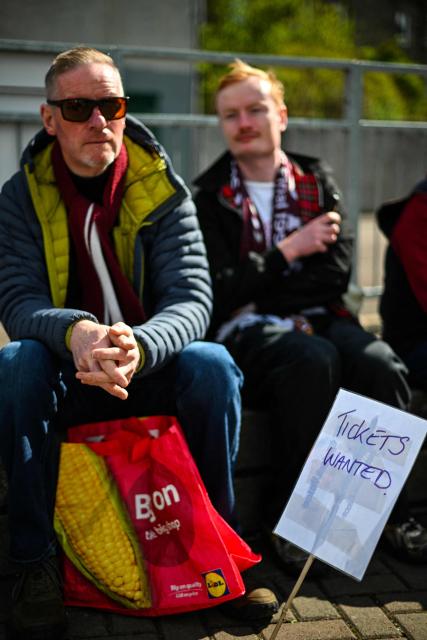 Hearts fans hope to get tickets before the start of the Scottish Premiership football match between Hearts and Rangers outside Tynecastle Stadium in Edinburgh on May 4, 2026. Hearts are hoping to become the first club other than Celtic and Rangers to win the Scottish crown since Aberdeen in 1985. (Photo by ANDY BUCHANAN / AFP)