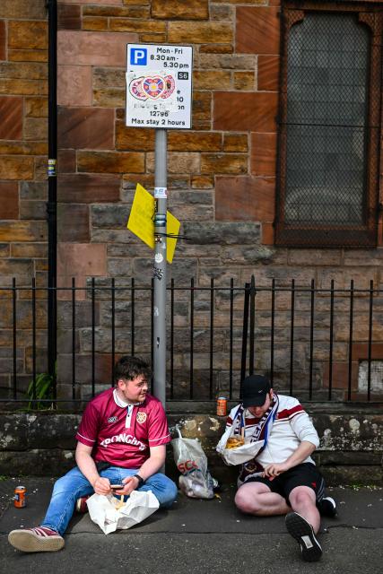 Hearts fans have a meal as they arrive before the start of the Scottish Premiership football match between Hearts and Rangers outside Tynecastle Stadium in Edinburgh on May 4, 2026. Hearts are hoping to become the first club other than Celtic and Rangers to win the Scottish crown since Aberdeen in 1985. (Photo by ANDY BUCHANAN / AFP)