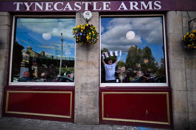 Hearts fans have pre-match drinks in the Tynecaslt Arms pub before the start of the Scottish Premiership football match between Hearts and Rangers near Tynecastle Stadium in Edinburgh on May 4, 2026. Hearts are hoping to become the first club other than Celtic and Rangers to win the Scottish crown since Aberdeen in 1985. (Photo by ANDY BUCHANAN / AFP)