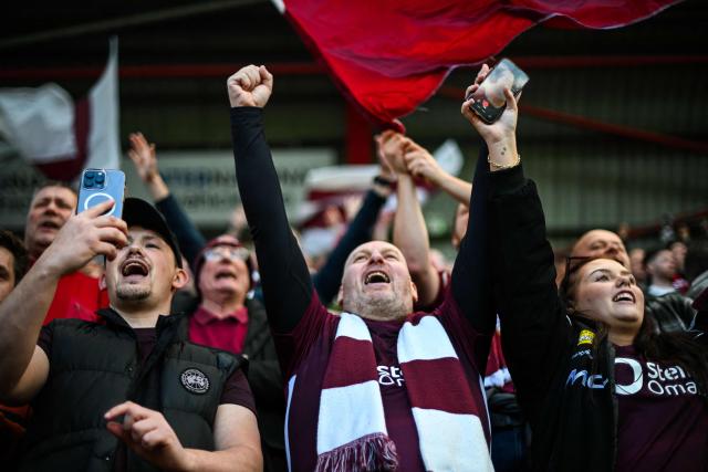 Hearts fans react before the start of the Scottish Premiership football match between Hearts and Rangers at Tynecastle Stadium in Edinburgh on May 4, 2026. Hearts are hoping to become the first club other than Celtic and Rangers to win the Scottish crown since Aberdeen in 1985. (Photo by ANDY BUCHANAN / AFP)