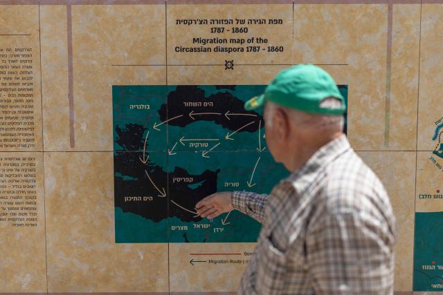 Riyad Gosh shows a migration map of the Circassian community in the Circassian village of Rehaniya in northern Israel, near the border with Lebanon on April 30, 2026. Like their Jewish and Arab neighbours, the Circassians -- Sunni Muslims who serve in the Israeli army -- have had their lives badly disrupted by the latest fighting that began on March 2, but eased with a mid-April ceasefire, which is now crumbling. The Circassians are an ethnic group indigenous to the North Caucasus, a mountainous region between the Black Sea and the Caspian Sea, in what is today primarily southern Russia. (Photo by Ilia YEFIMOVICH / AFP)