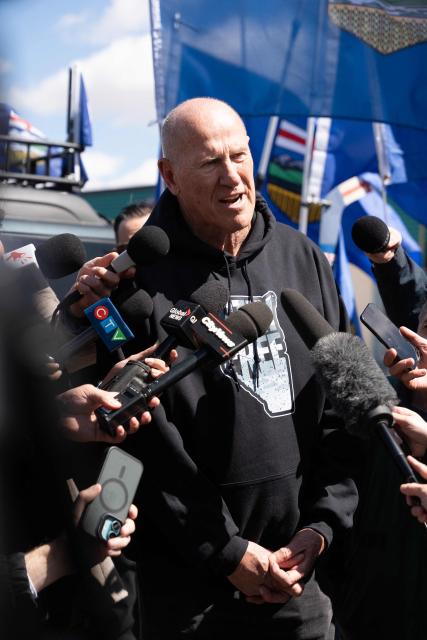 Separatist leader Mitch Sylvestre speaks to reporters as he leads a rally in front of the Elections Alberta headquarters in Edmonton, Canada, on May 4, 2026, as they submit boxes of signatures in the hope of triggering an independence referendum. Alberta separatists submitted stacks of boxes to election officials on Monday, which they said contained the signatures of more than 300,000 supporters, enough names to force an independence referendum in Canada's oil-rich province. A boisterous crowd of several hundred waved the blue provincial flag on a bright, clear day, cheering as separatist leader Mitch Sylvestre delivered the petitions to Elections Alberta. (Photo by Henry MARKEN / AFP)