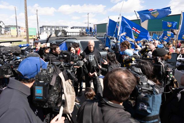 Separatist leader Mitch Sylvestre speaks to reporters as he leads a rally in front of the Elections Alberta headquarters in Edmonton, Canada, on May 4, 2026, as they submit boxes of signatures in the hope of triggering an independence referendum. Alberta separatists submitted stacks of boxes to election officials on Monday, which they said contained the signatures of more than 300,000 supporters, enough names to force an independence referendum in Canada's oil-rich province. A boisterous crowd of several hundred waved the blue provincial flag on a bright, clear day, cheering as separatist leader Mitch Sylvestre delivered the petitions to Elections Alberta. (Photo by Henry MARKEN / AFP)