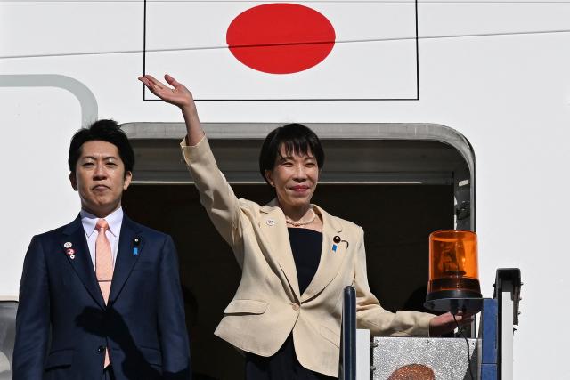 Japan's Prime Minister Sanae Takaichi waves as she departs from a RAAF base in Canberra on May 5, 2026, after a three-day official visit to Australia. (Photo by Saeed KHAN / AFP)