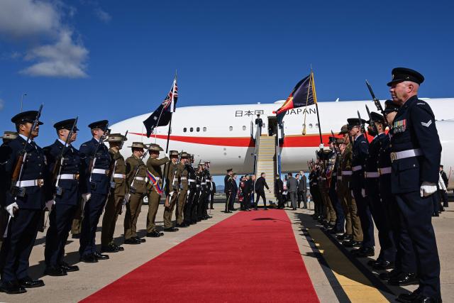 Members of the Australian armed forces stand on alert during the departure of Japan’s Prime Minister Sanae Takaichi at a Royal Australian Air Force base in Canberra on May 5, 2026. (Photo by Saeed KHAN / AFP)