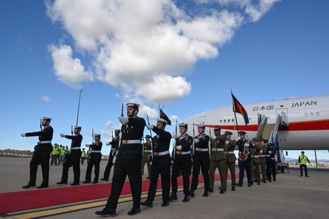 Members of the Australian armed forces march back after Japan’s Prime Minister Sanae Takaichi boarded her aircraft at a Royal Australian Air Force base in Canberra on May 5, 2026, after a three-day official visit to Australia. (Photo by Saeed KHAN / AFP)