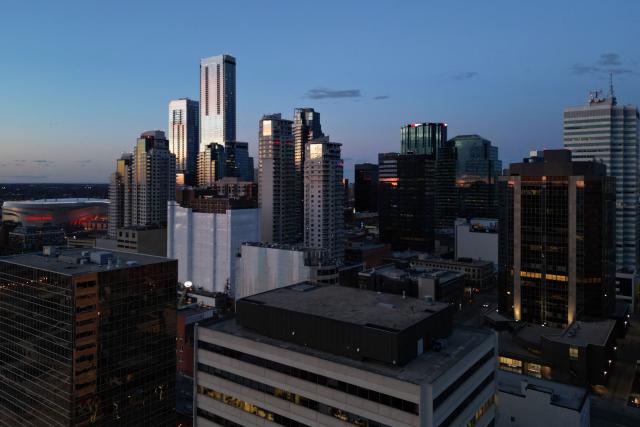 This aerial view shows the downtown skyline in Edmonton, Canada, at sunset on May 3, 2026. Separatists who want oil-rich Alberta to break away from Canada head to the provincial capital Edmonton on May 4, 2026 to submit a petition that they say has enough signatures to force a referendum. The pro-independence camp in the western province of five million people had existed on the margins for decades, but the movement has gathered pace in recent months and is closer than ever to triggering a vote. (Photo by Daphné LEMELIN / AFP)