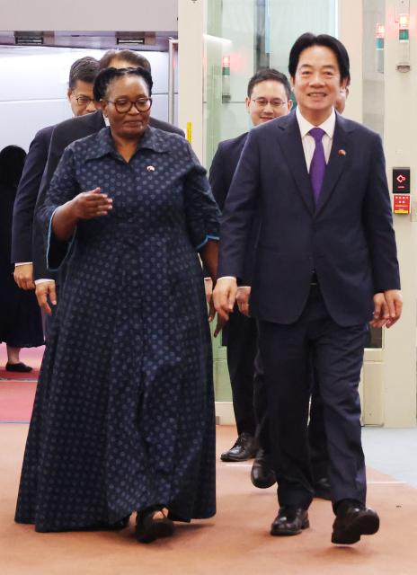Taiwan President Lai Ching-te (R) and Eswatini Deputy Prime Minister Thulisile Dladla ?L) arrive at Taiwan Taoyuan International Airport following his visit to Eswatini, in Taoyuan on May 5, 2026. (Photo by I-Hwa Cheng / AFP)