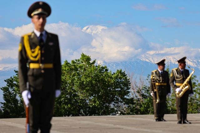 Armenian honour guards and military musicians wait for the arrival of French President at the Tsitsernakaberd Armenian Genocide Memorial, with Mount Ararat seen in distance, in Yerevan on May 5, 2026. (Photo by Ludovic MARIN / AFP)