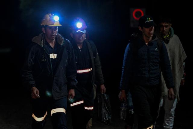 Miners walk around the site of an explosion at a coal mine in Sutatausa, Cundinamarca department, Colombia on May 4, 2026. Nine miners died and six others were rescued following an explosion at a legal coal mine in central Colombia on May 4, 2026, according to the final tally released by authorities at the end of the search operation. (Photo by Luis ACOSTA / AFP)