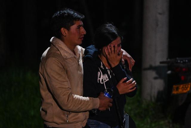 Relatives mourn the death of nine miners after an explosion at a coal mine in Sutatausa, Cundinamarca department, Colombia on May 4, 2026. Nine miners died and six others were rescued following an explosion at a legal coal mine in central Colombia on May 4, 2026, according to the final tally released by authorities at the end of the search operation. (Photo by Luis ACOSTA / AFP)